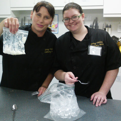 Students show off their homemade ice cream in their science lab