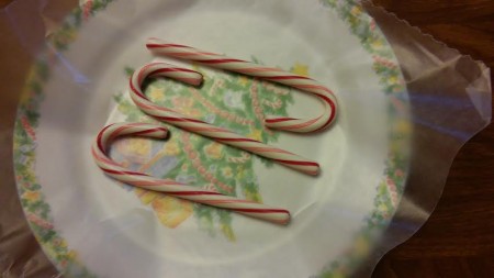 Three candy canes, cellophane removed.